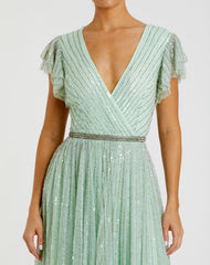 Green Sequined Wrap Over Ruffled Cap Sleeve Gown